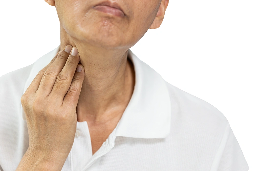 Middle-aged man touching his neck lump.