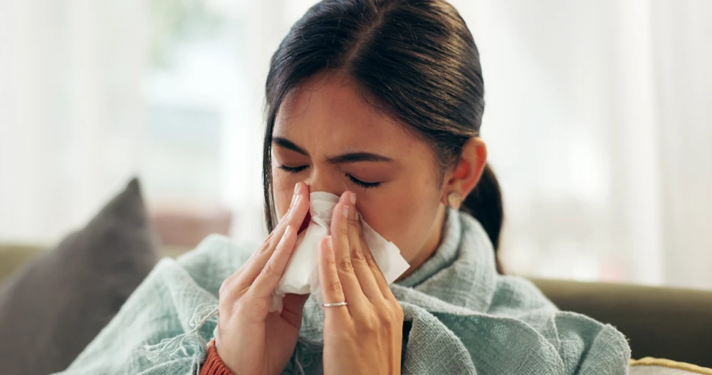 Female patient experiencing symptoms of a sinus infection, considering visiting an ENT doctor in Singapore.